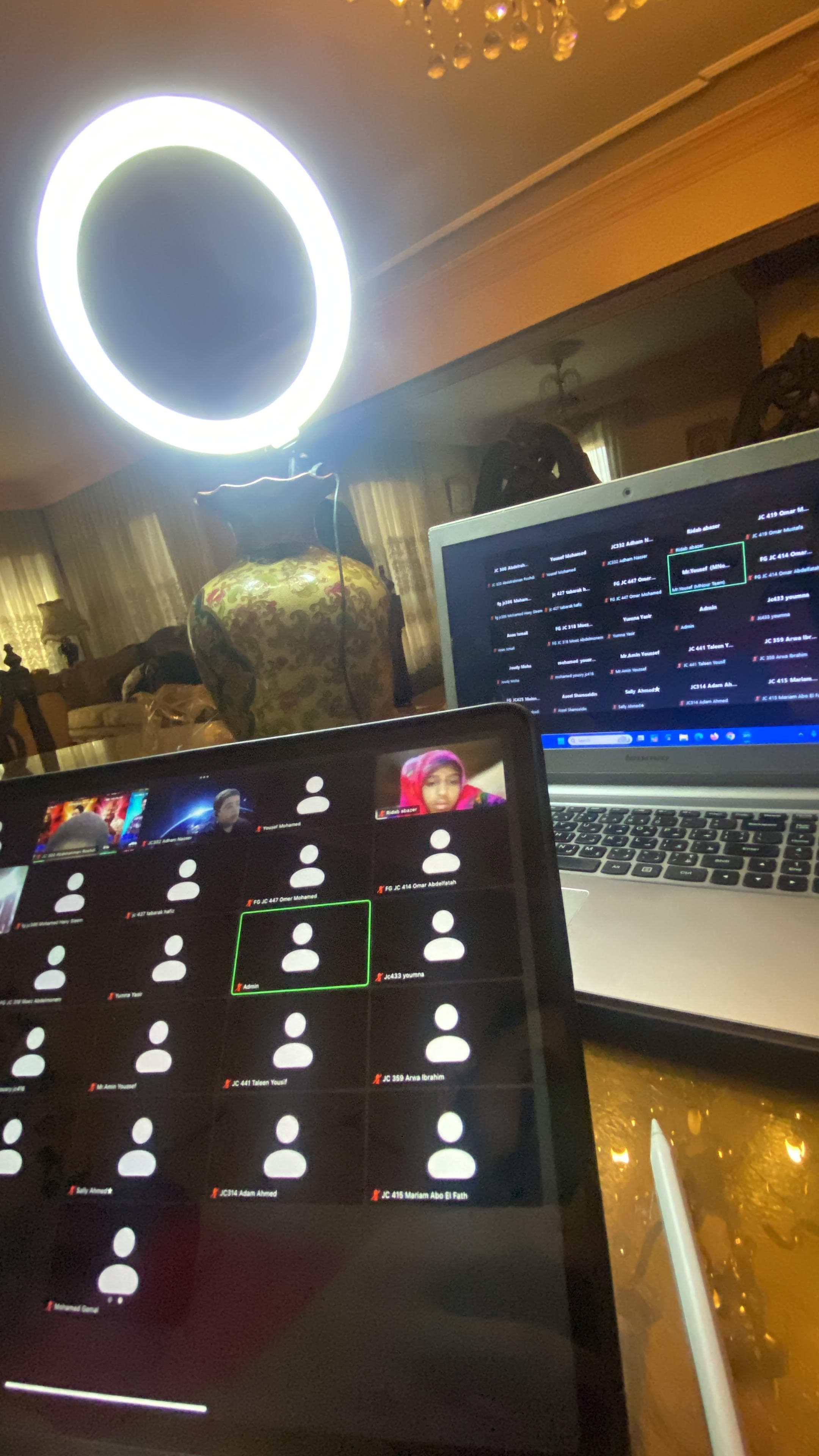 An online lesson set up at home: ring light, laptop and tablet ready for the call.